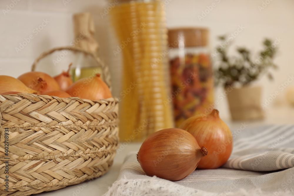 Fresh onions on countertop in modern kitchen, closeup
