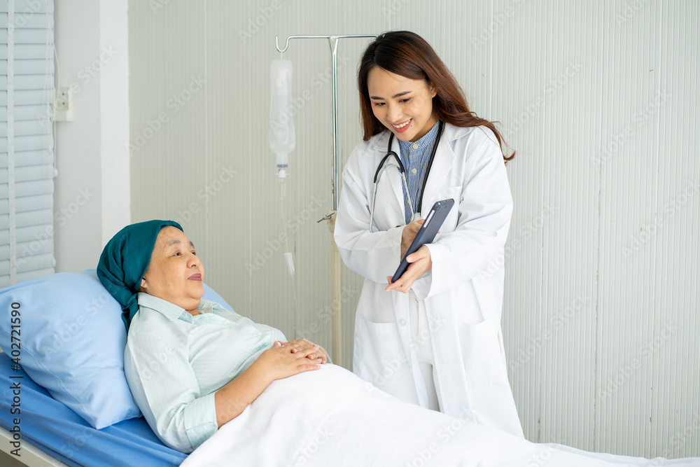 Asian medical doctor with stethoscope diagnosis old senior cancer patient on hospital bed Asian medical doctor with stethoscope diagnosis old senior cancer patient on hospital bed