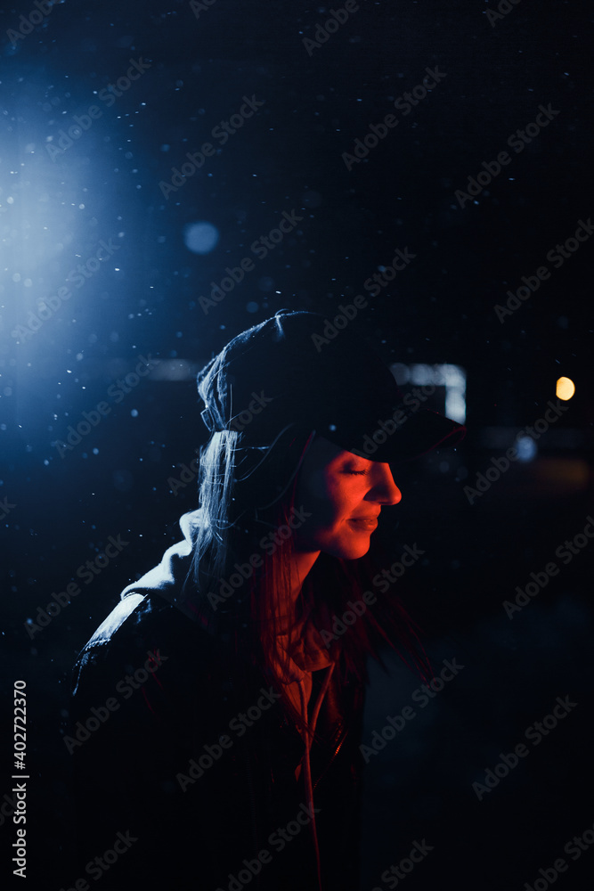 Girl on the street in the dark.