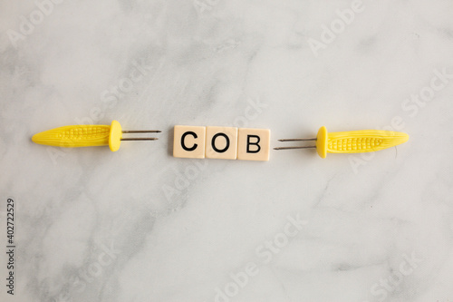 scrabble tiles on the marble countertop spelling the word cob