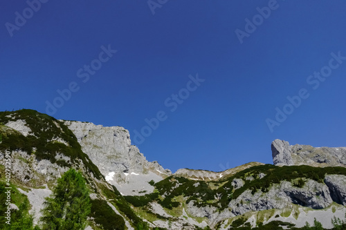 wonderful rocky mountains with some green plants and blue sky