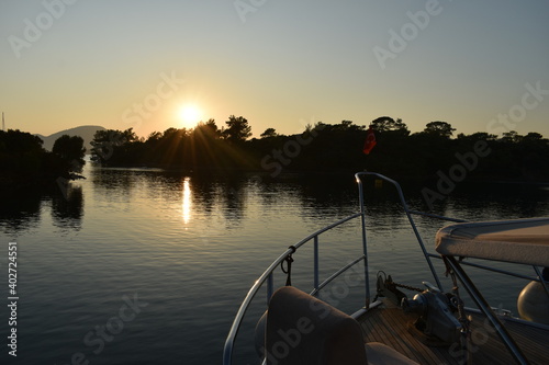 Fototapeta Naklejka Na Ścianę i Meble -  Motoryacht anchored at bay before the sunset