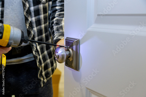 Carpenter installation at interior wood door lock
