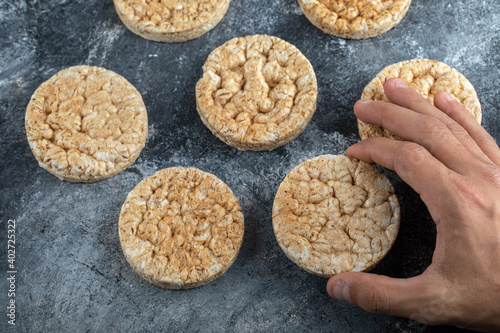 Male hands holding crispbread on marble background