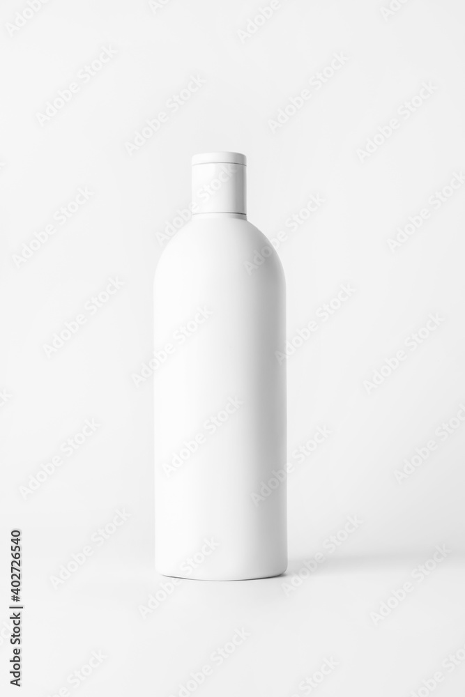 White bottle with shampoo on a light background.. White bottle with shampoo on a light background..
