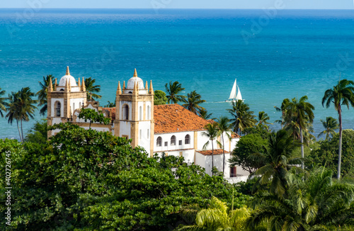 View of the Igreja do Carmo de Olinda - Mount Carmel Chruch, Olinda, Pernambuco, with the sea and a sailboat in the background.