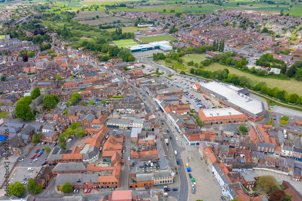 Aerial photo of the historical village town centre of Selby in York North Yorkshire in the UK showing the rows of newly built houses along side the River Ouse and farmers fields in the summer time