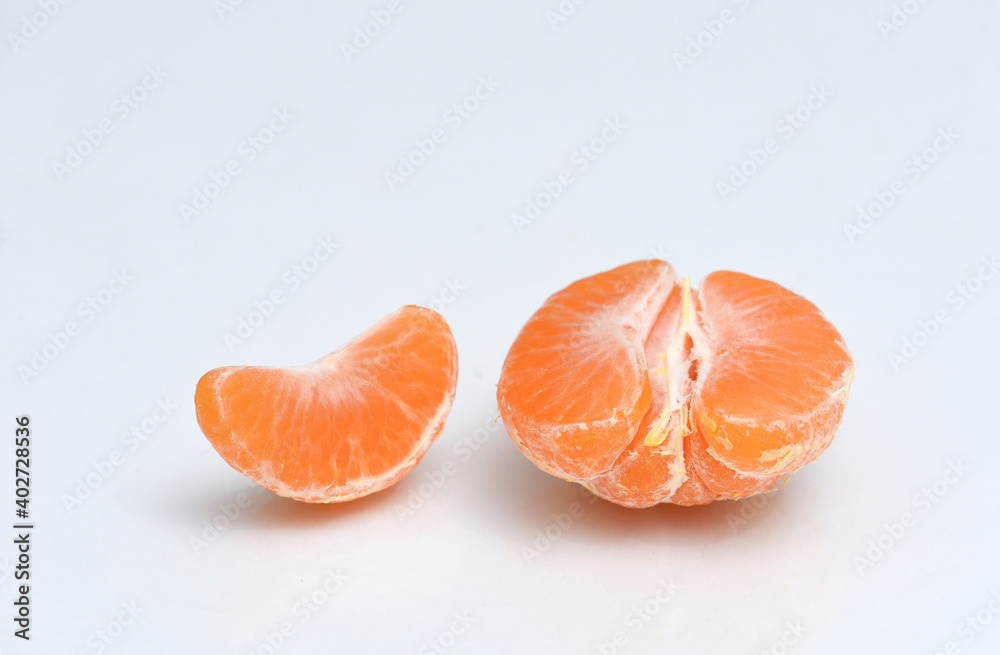 Peeled tangerine on white background
