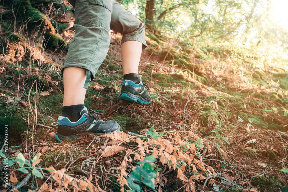 Hiking shoes in action on mountain desert trail path. Close up of female hikers shoes Hiking shoes in action on mountain desert trail path. Close up of female hikers shoes