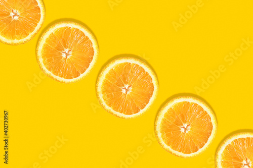 Orange round slices on an orange background diagonally with space for text. Template, layout of your advertisement.