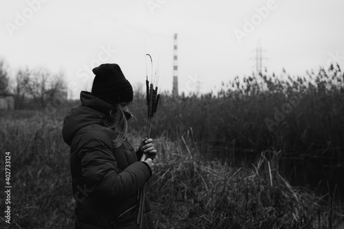 Young girl on background of factory pipe