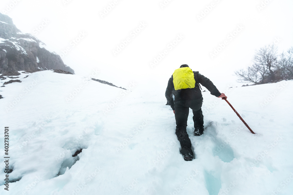 Hiker walking through a winter landscape Hiker walking through a winter landscape