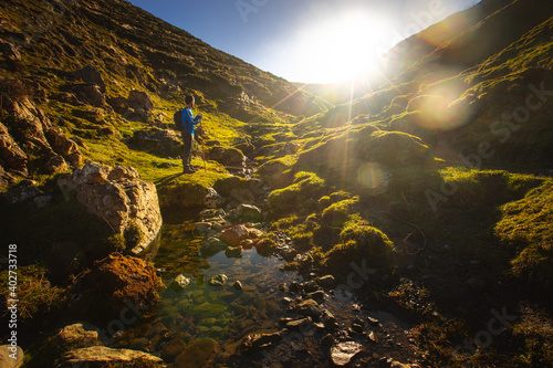 View at Aralar mountain range with a small river and the sun reaching high. photo