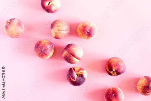 Peaches pattern. Fresh fruits background. Peach on pastel pink background. Flat lay, top view, copy space