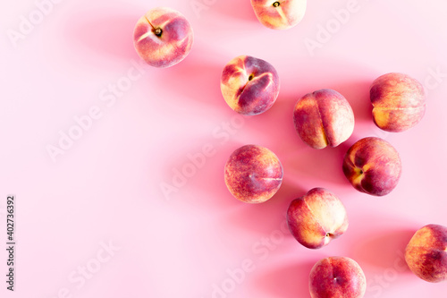 Peaches pattern. Fresh fruits background. Peach on pastel pink background. Flat lay, top view, copy space