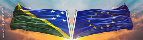 Double Flag  European Union vs Solomon Islandsflag waving flag with texture sky clouds and sunset background photo