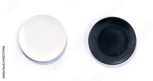 Empty Matte White and Black plates isolated on white background top view