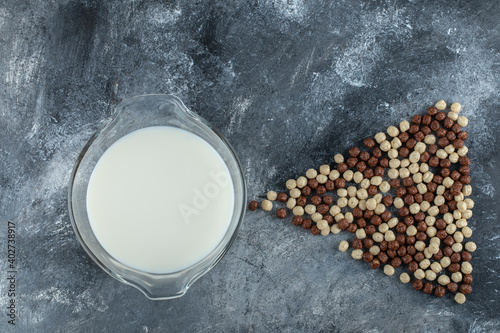 Fresh milk and cereal balls on marble background