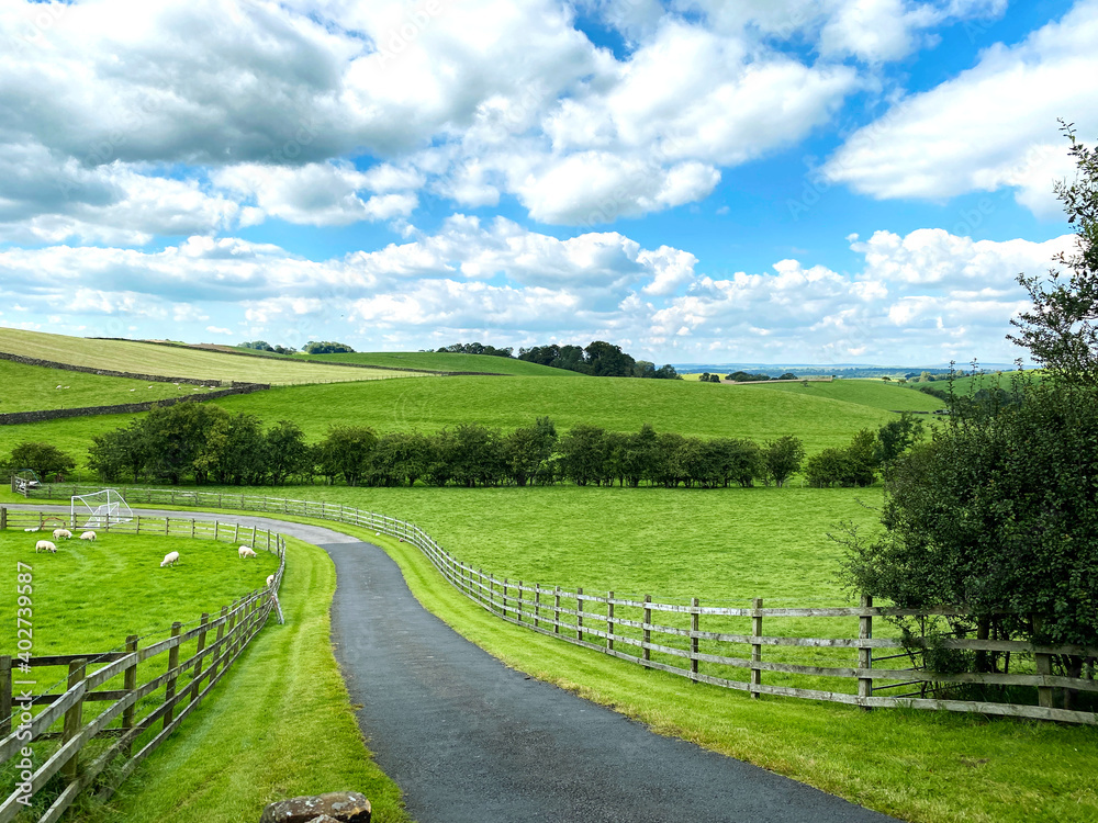 Narrow lane leading from, Yarlside Lane, with fields and hills in the distance in, Horton, Gisburn, UK Narrow lane leading from, Yarlside Lane, with fields and hills in the distance in, Horton, Gisburn, UK