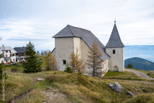 Church of Saint Ursula on the top of Urslja gora, a mountain in the Koroska region of Slovenia on a sunny day photo