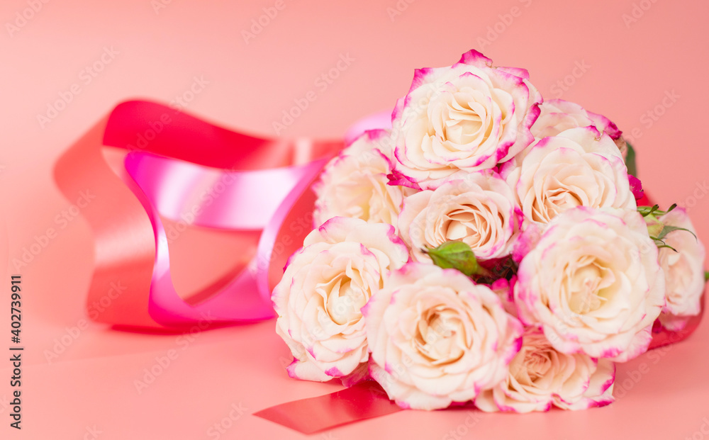 delicate bouquet of bushy peony roses with bright ribbons in the shape of hearts on a pink background, the concept of congratulations on Valentine's day delicate bouquet of bushy peony roses with bright ribbons in the shape of hearts on a pink background, the concept of congratulations on Valentine's day