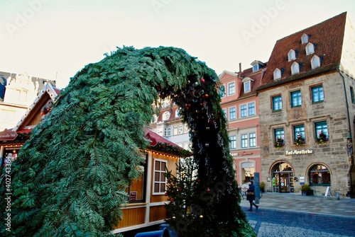 Coburg, Germany:  Weihnachtsmarkt (Christmas Market) Evergreen arch leading to the Christmas Market with an traditional apothecary (Hofapotheke am Markt) in the background. 
