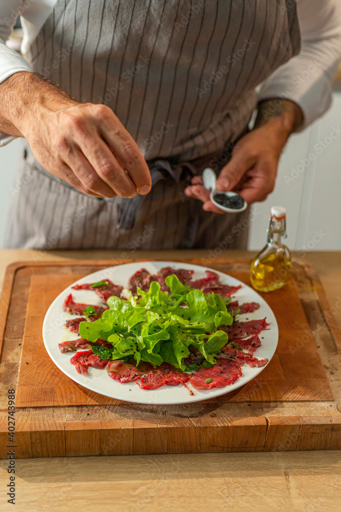 Prepared meat carpaccio on a serving plate