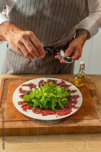 Prepared meat carpaccio on a serving plate