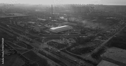 Flying over an industrial area smoke, sun, backlight, black and white video, disaster