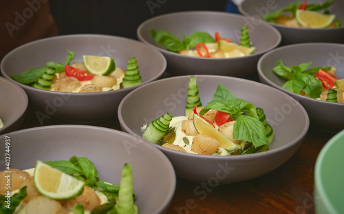 Cucumber and rocket salad with sesame seeds and lemon is on a wooden table. close-up.