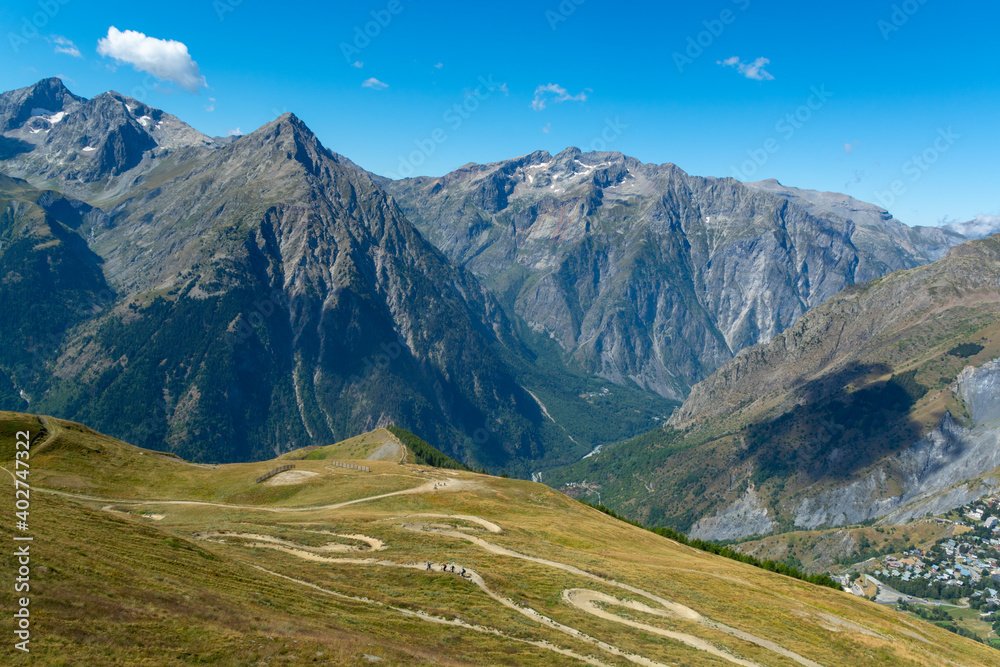 Hiking near ski station Les deux Alpes and view on Alpine mountains peaks in summer, Isere, France Hiking near ski station Les deux Alpes and view on Alpine mountains peaks in summer, Isere, France