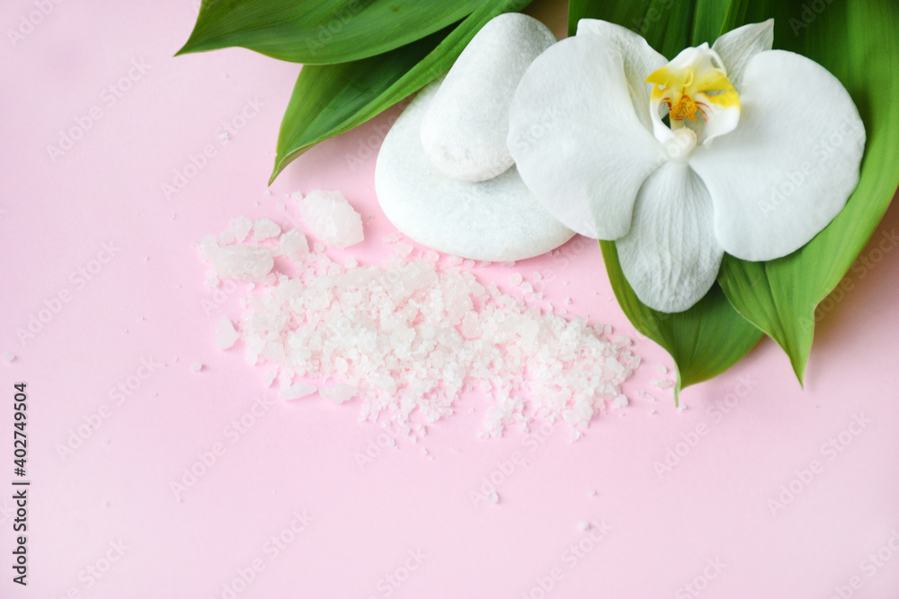 Flat lay composition with white spa sea salt and white orchid with space for text on pink background. Meditation and minimalism. copyspase flatlay. Spa cosmetic and Beauty concept, top view. Flat lay composition with white spa sea salt and white orchid with space for text on pink background. Meditation and minimalism. copyspase flatlay. Spa cosmetic and Beauty concept, top view.