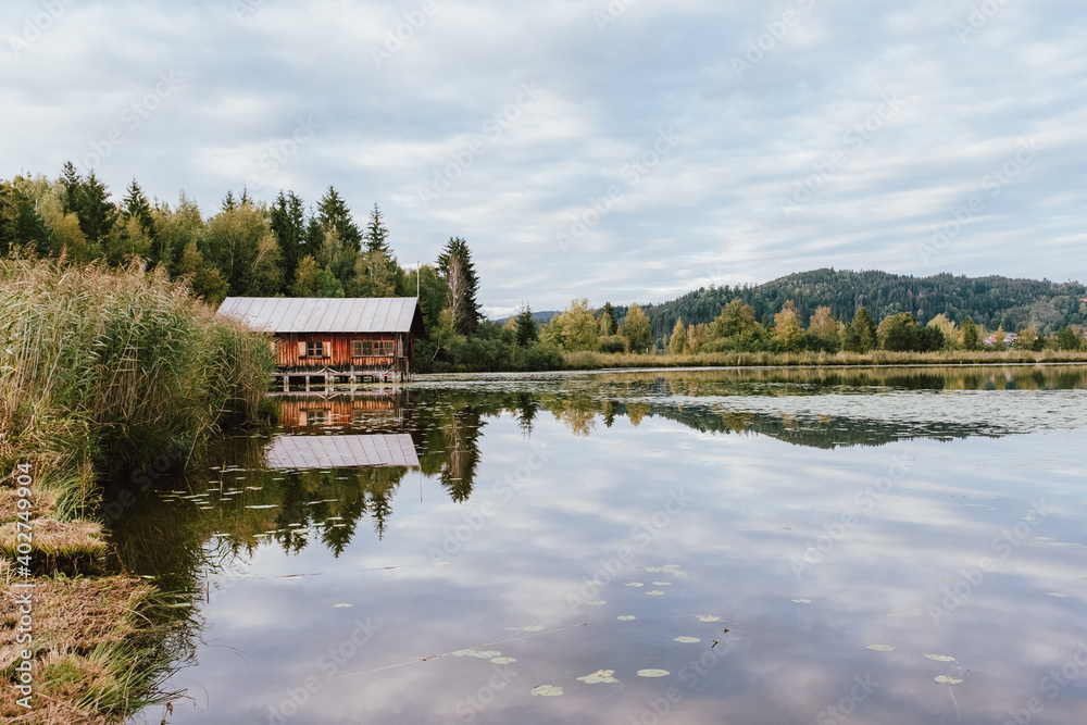 Floating house on a beautiful lake during autumn. Perfect water reflection on the lake