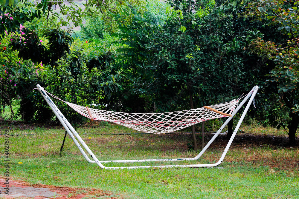 White hammock in a peaceful garden. White hammock in a peaceful garden.