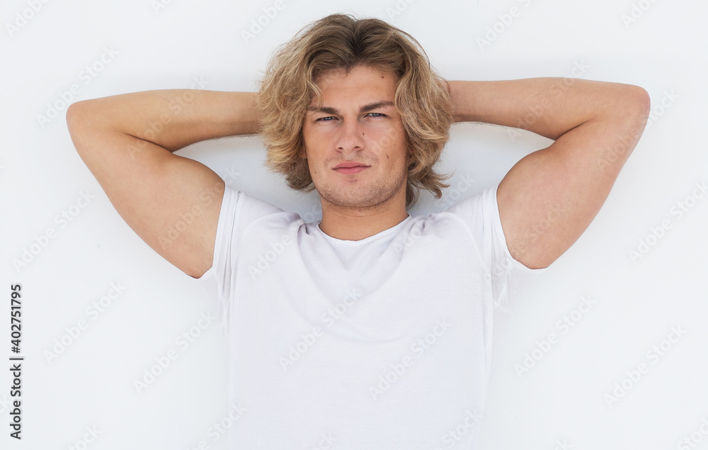 Handsome young man in blank white shirt posing in studio, fashion and people concept. Handsome young man in blank white shirt posing in studio, fashion and people concept.