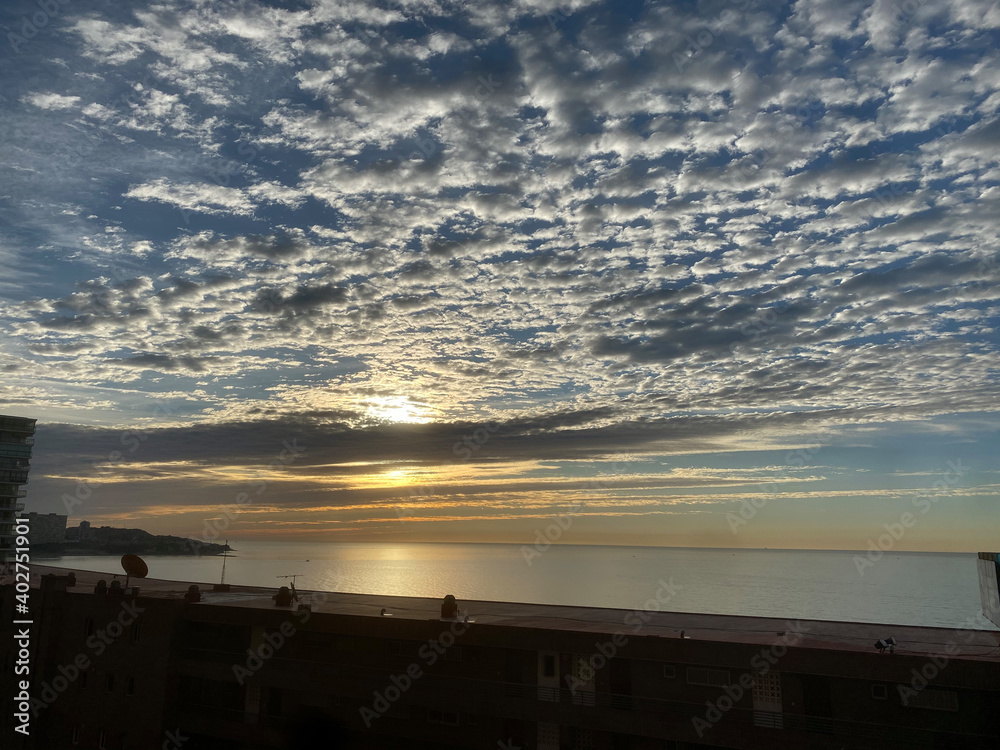 Obraz premium beautiful and colorful sunrise in the beach with some clouds