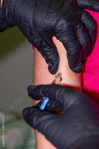 Covid-19: Nurse's hand with black people injects a vaccine against Covid-19 (SARS-COV-2) into the arm of a child.