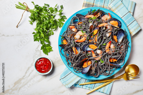 Black pasta with seafood on a marble background © myviewpoint