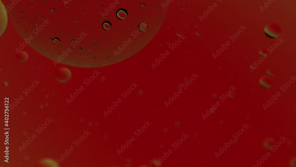 Abstract background with bubbles monochromatic effect. Blurred oil drop on water with bright lights background. Red abstract backdrop with bubbles Abstract background with bubbles monochromatic effect. Blurred oil drop on water with bright lights background. Red abstract backdrop with bubbles