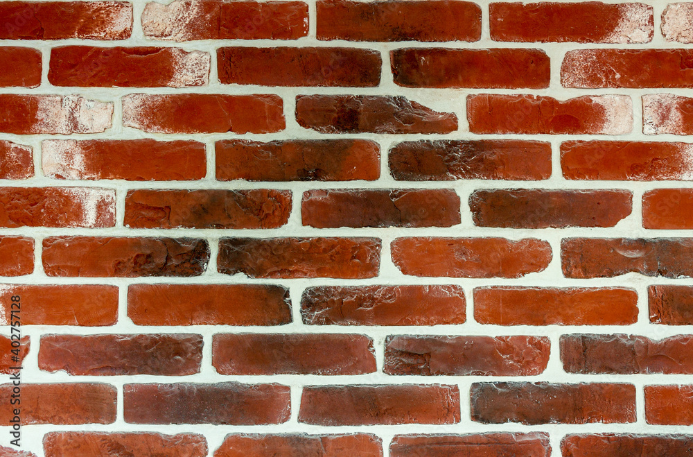 Obraz premium The wall is of old red brick with white seams. Texture. Background.