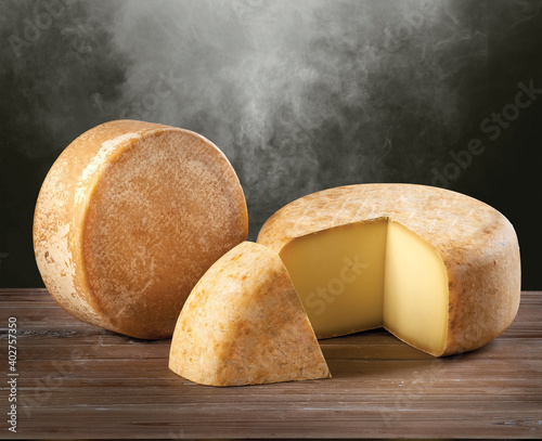 Round parmesan cheese on wood background