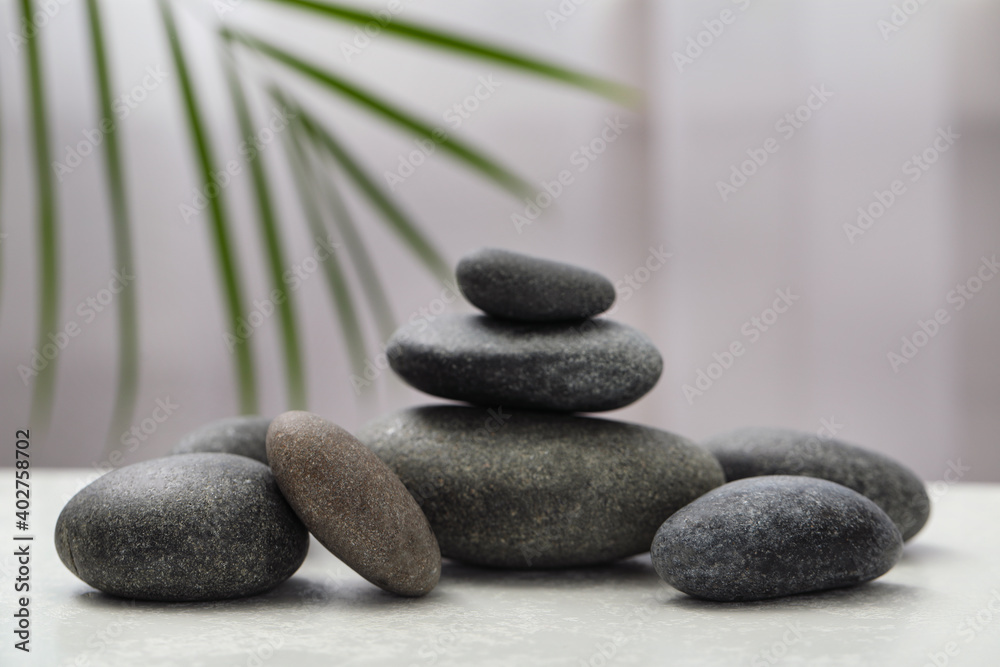 Spa stones on white table indoors. Zen and harmony Spa stones on white table indoors. Zen and harmony