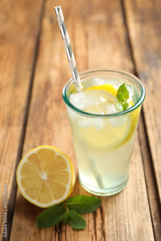 Natural lemonade with mint and fresh fruit on wooden table, closeup. Summer refreshing drink Natural lemonade with mint and fresh fruit on wooden table, closeup. Summer refreshing drink