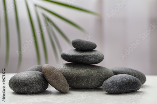 Spa stones on white table indoors. Zen and harmony