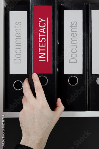 Intestacy. Folder with label on the shelf of a lawyer. Red label with text in focus. photo