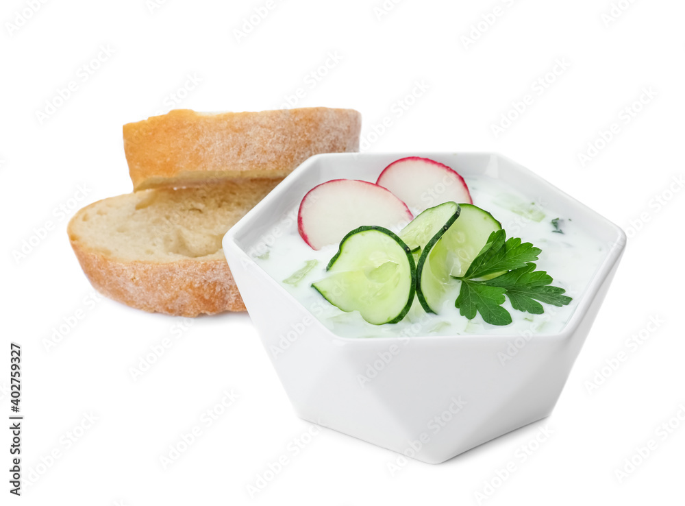 Delicious cold summer soup and bread on white background