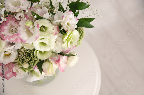 Bouquet of beautiful flowers on table in room, closeup with space for text. Interior design