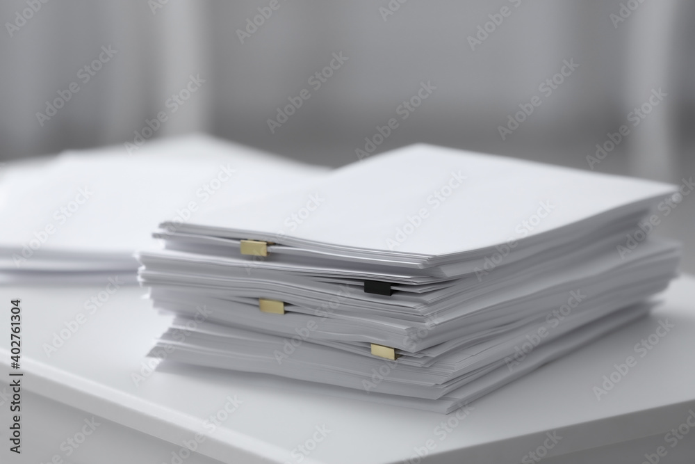 Stack of blank paper on white table