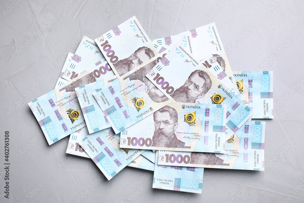 Ukrainian money on grey background, flat lay Ukrainian money on grey background, flat lay