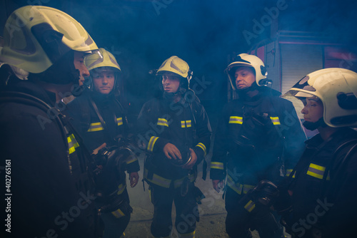 Group of firemen in the fire department organizing action plan for safe execution